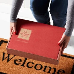 Deluxe Signature Charcuterie Gift Box -Hickory Farms Elegant Shop mailer box doorstep hands alt